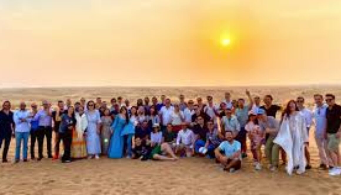 Travel group in Dubai enjoying a desert safari at sunset