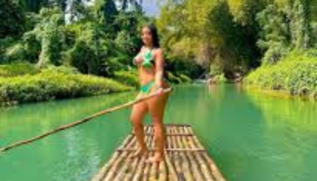 Tourists go bamboo rafting on the Martha Brae River in Jamaica, guided by a local captain.”