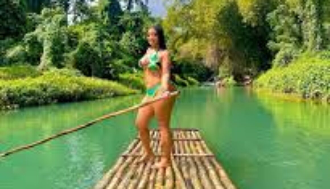 Tourists go bamboo rafting on the Martha Brae River in Jamaica, guided by a local captain.”